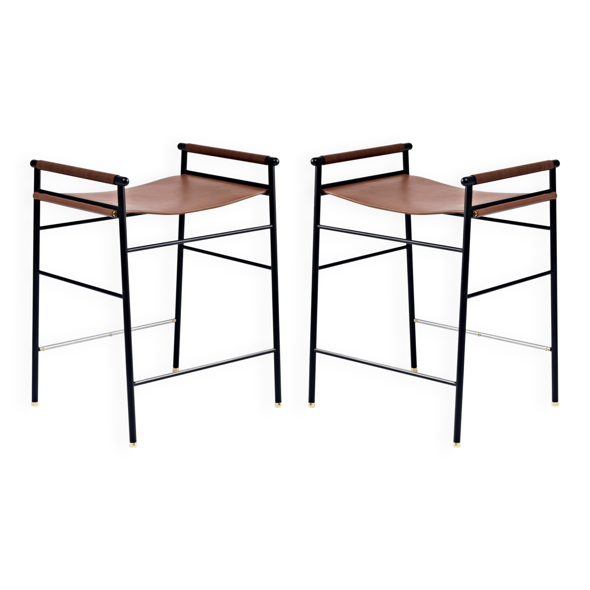 Pair of backless bar stools in brown and black metal.