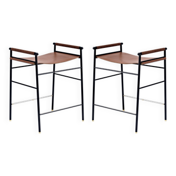 Pair of backless bar stools in brown and black metal.