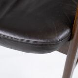 Armchair in rosewood and black leather of danish design from 1976.