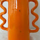 Handmade abstract orange ceramic vase with wavy handles