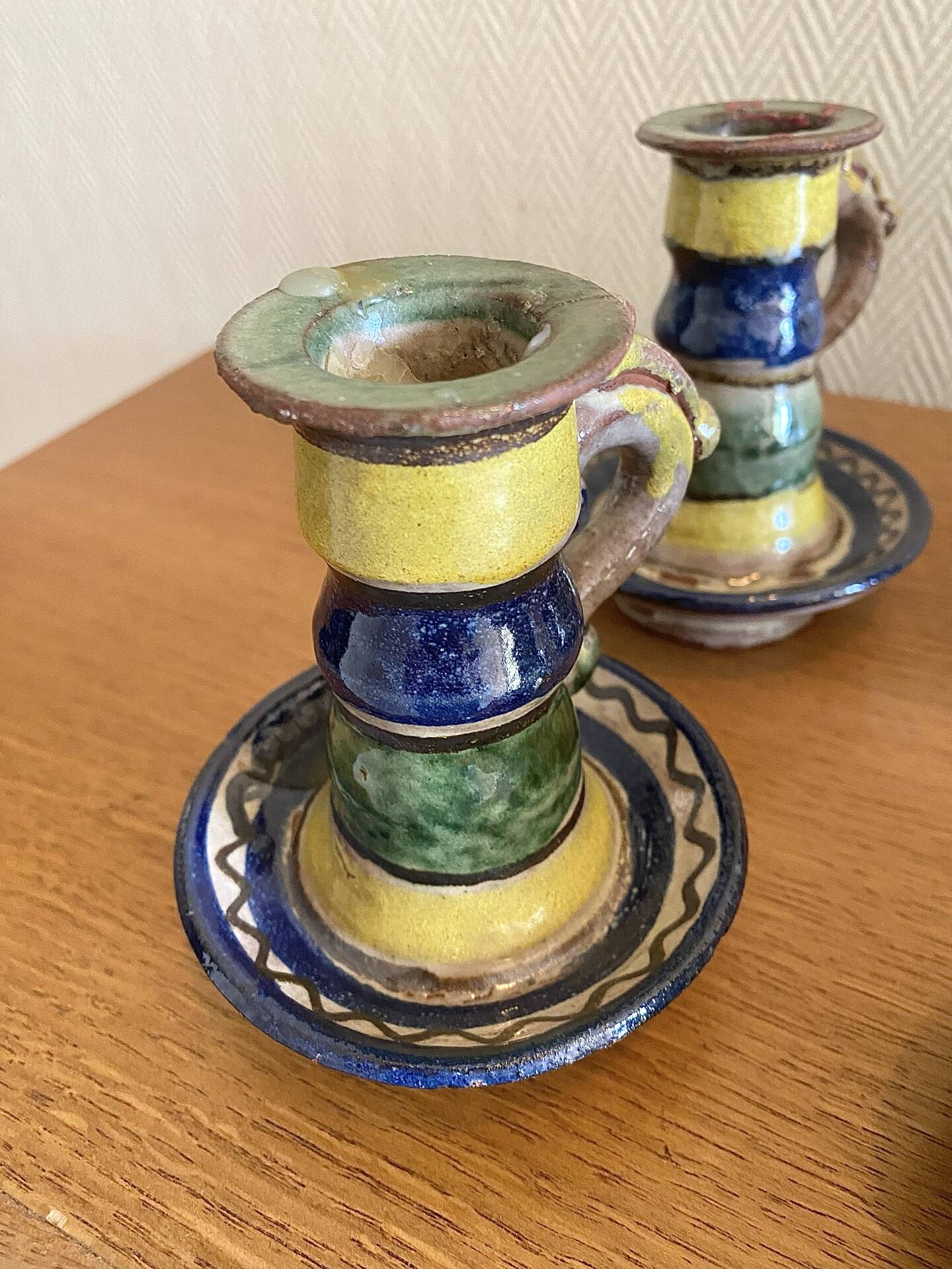 Many old glazed terracotta candlesticks.