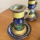 Many old glazed terracotta candlesticks.