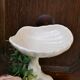 Dartmouth pottery koi carp supporting a shell-shaped dish/vase.