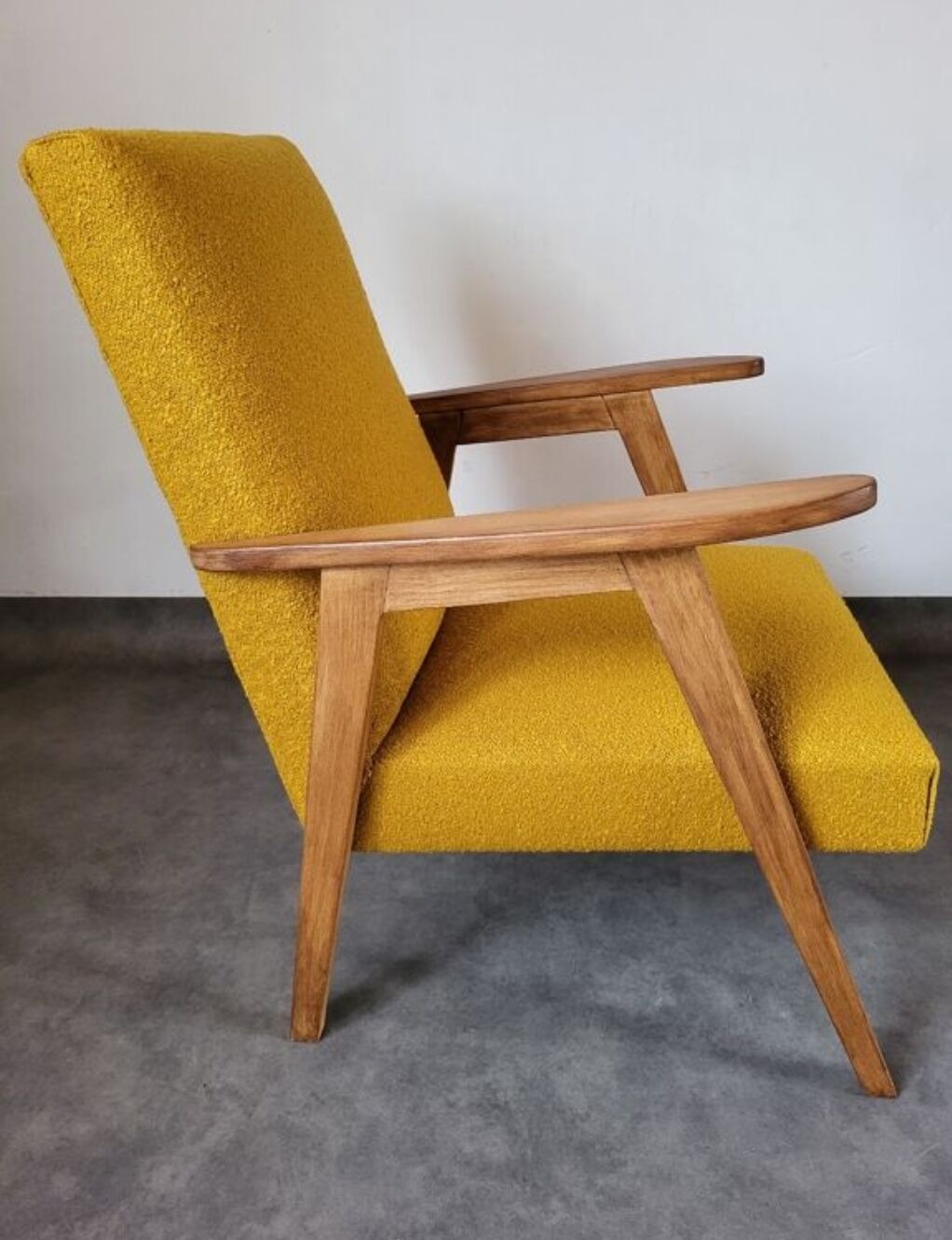 Curly yellow Scandinavian armchair