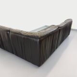 Vintage corner sofa composed of 3 modules in black leather with integrated bed.