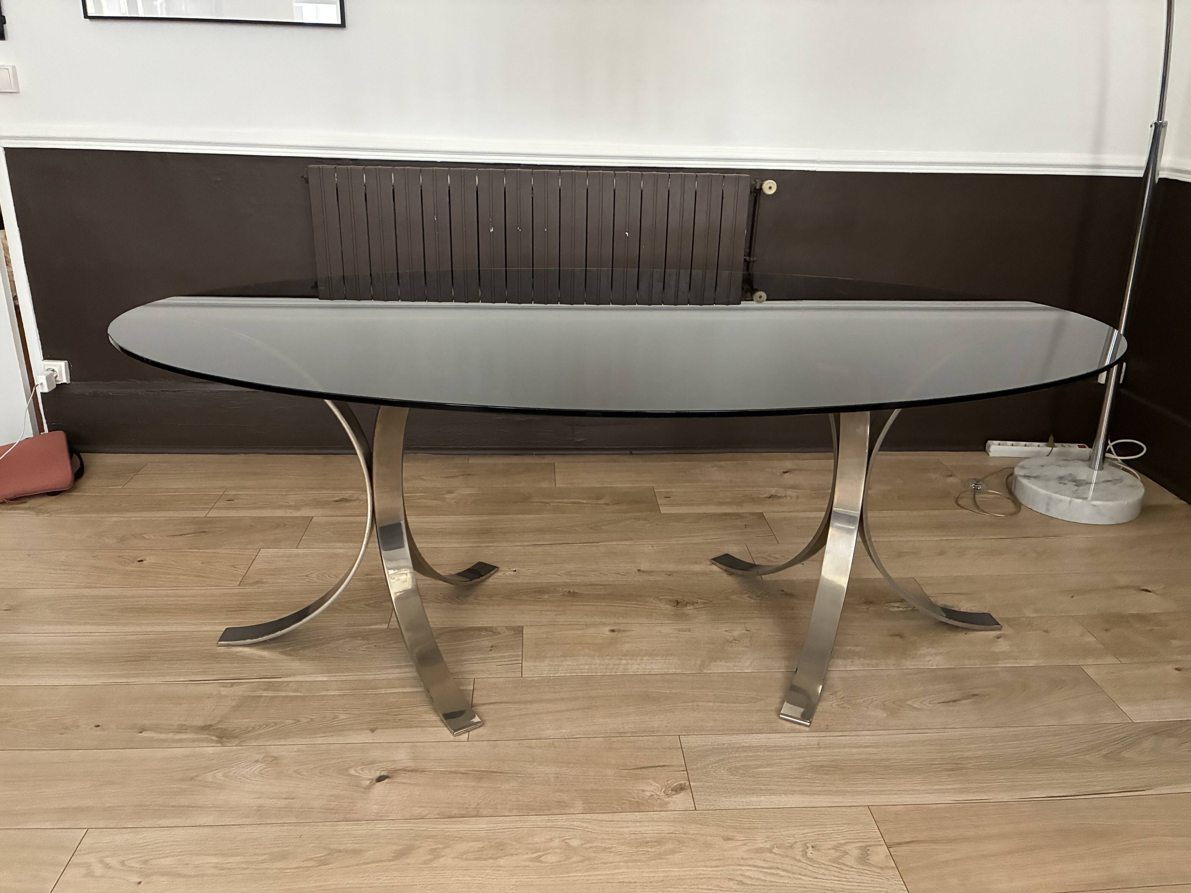 Smoked glass table with a metal base.