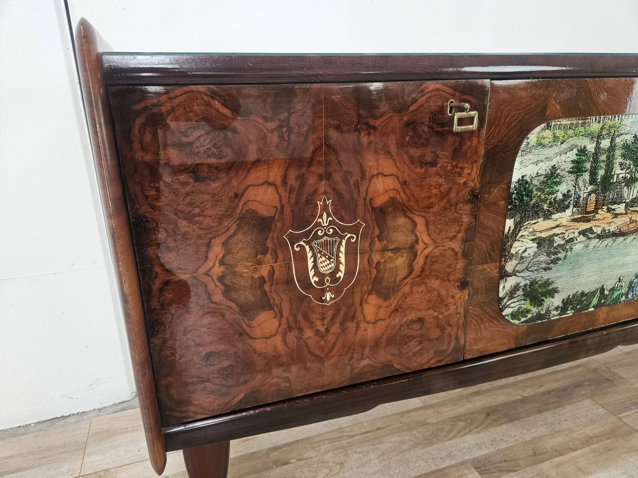 1950s mahogany sideboard with a glass top and central bar.