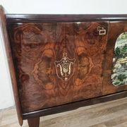 1950s mahogany sideboard with a glass top and central bar.