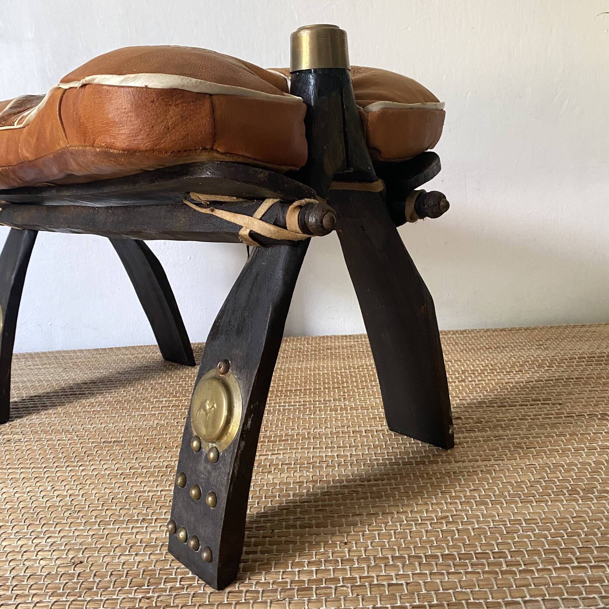 Pair of low Egyptian stools, camel saddles in wood, leather and brass