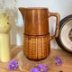 Antique vintage ceramic pitcher or jug from Sarreguemines, France. Brown with a pink interior, imitation basket.
