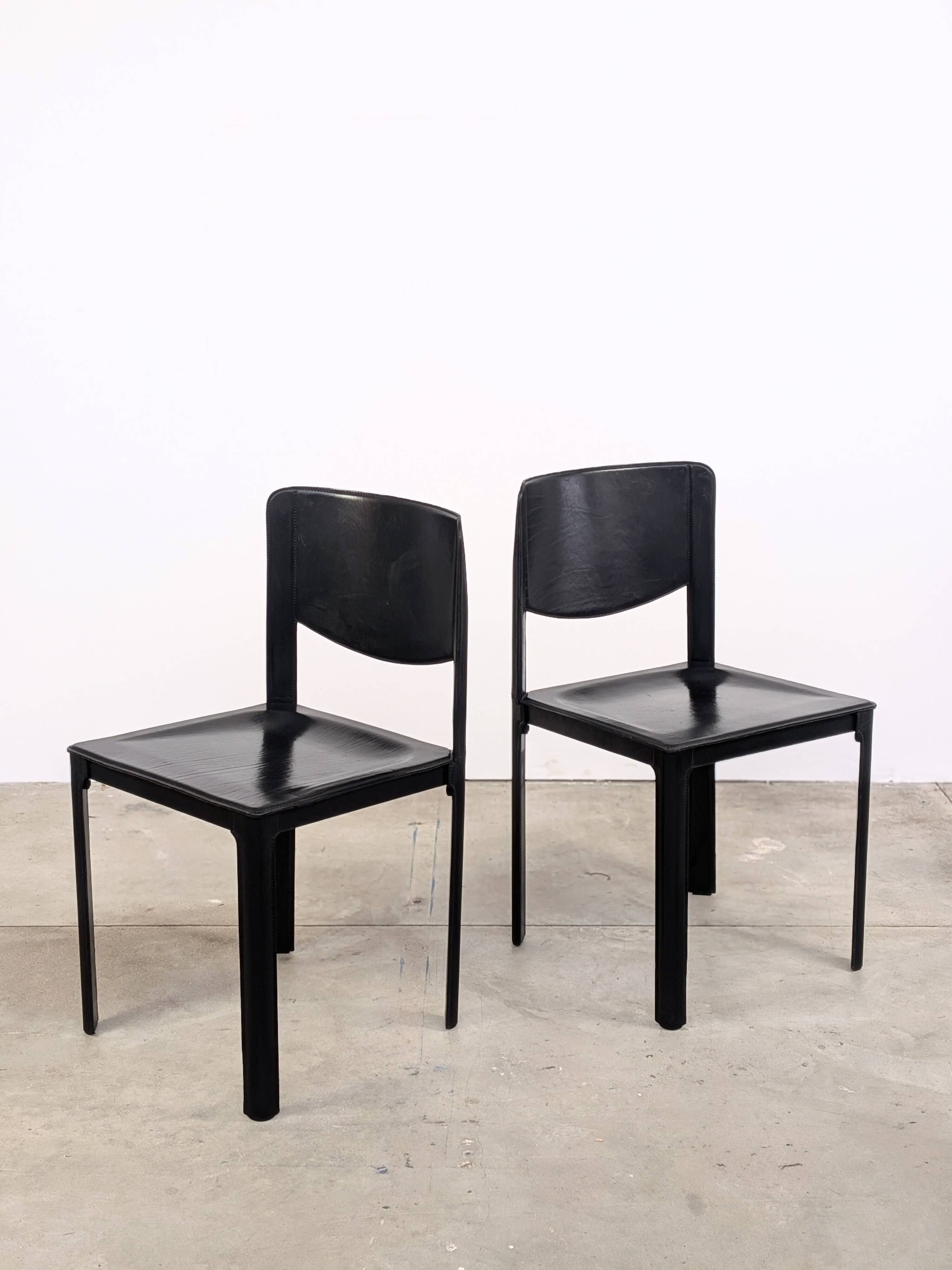 Pair of Matteo Grassi chairs in black saddle leather, 1980s.