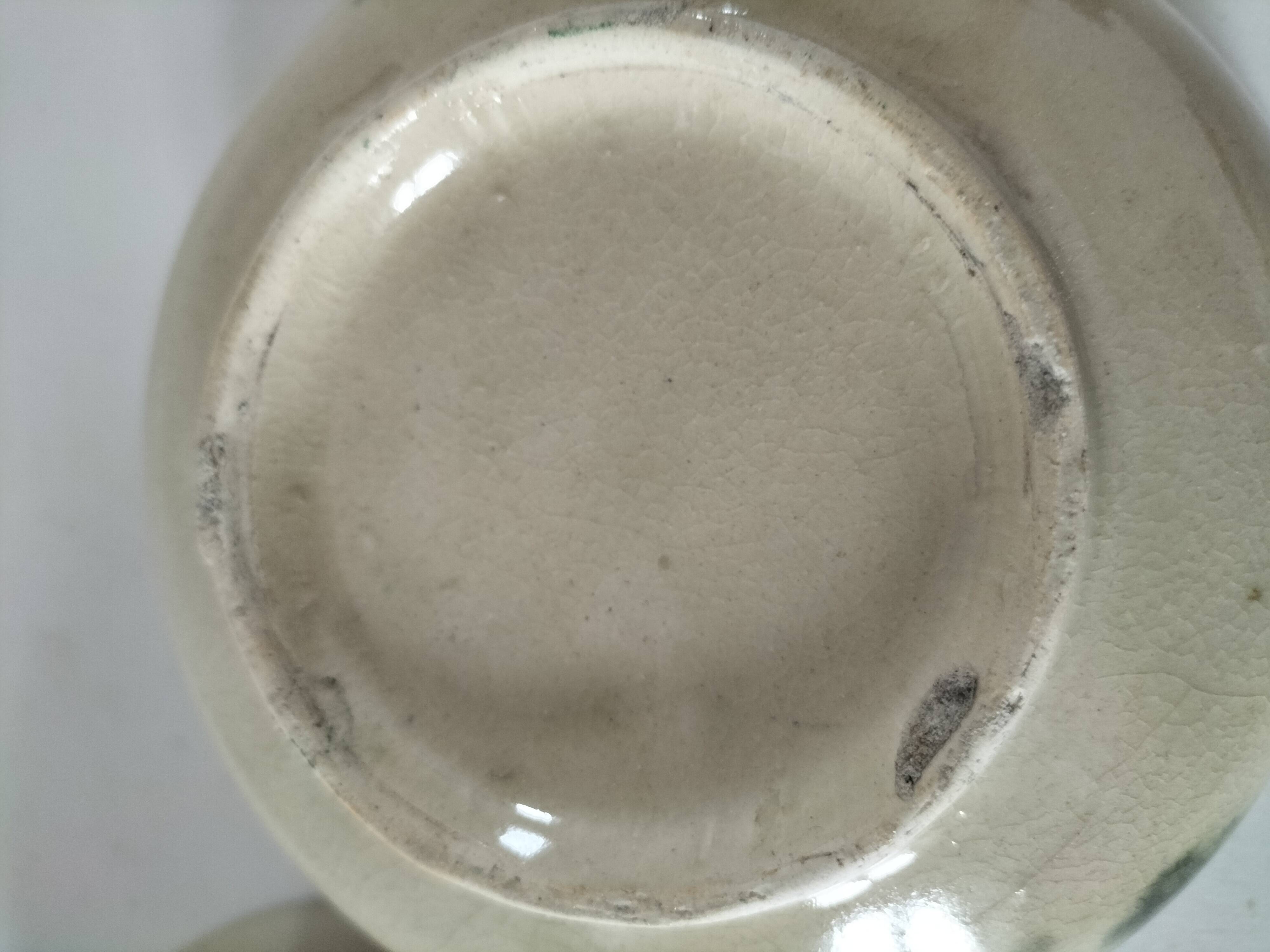 Two large vintage bowls in pastel decor on mini pedestals.