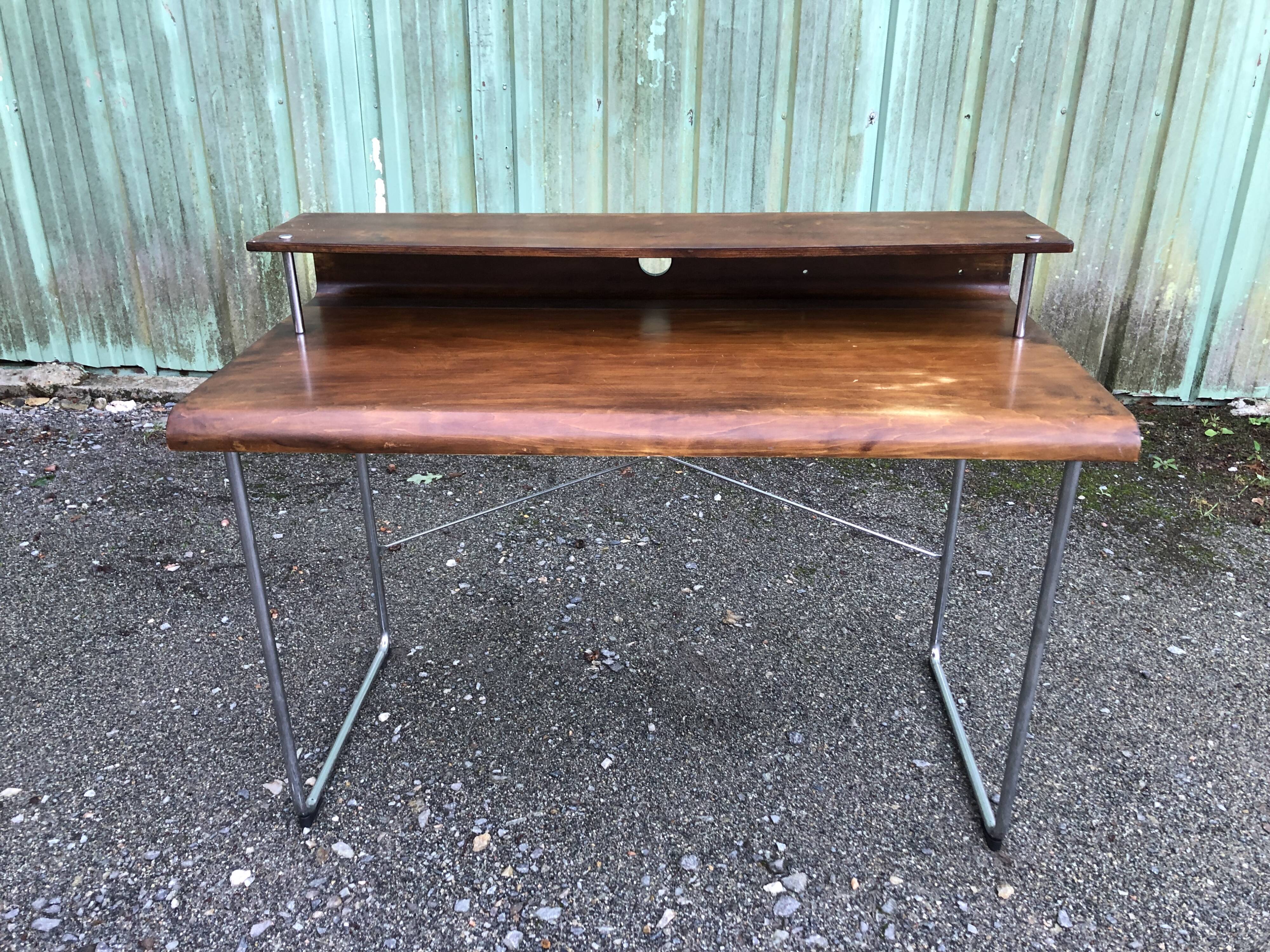 Design desk in formed glued laminated wood with chrome tubular base.
