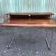 Design desk in formed glued laminated wood with chrome tubular base.