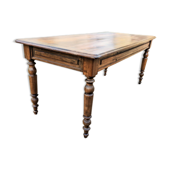 Old French farmhouse table in walnut with turned legs.