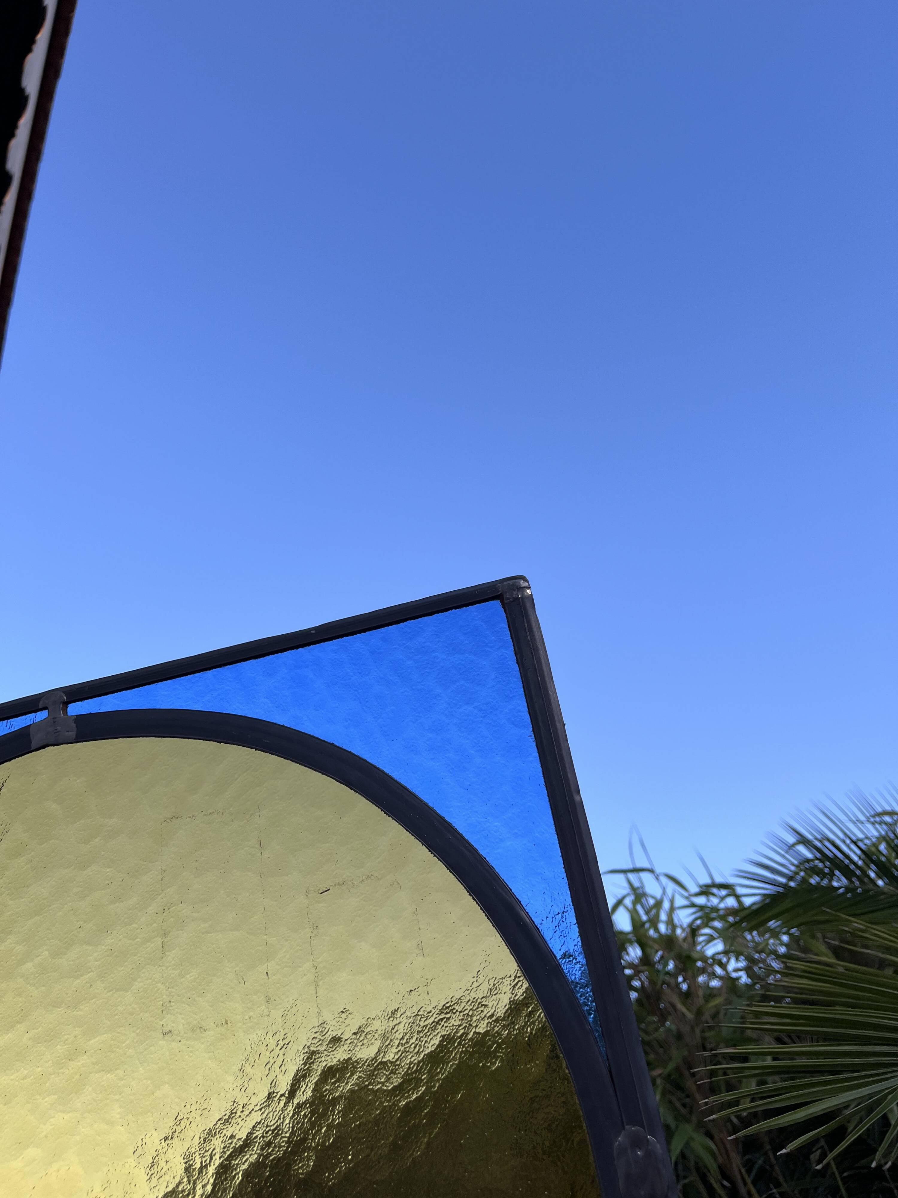 Pair of antique blue and yellow stained glass windows