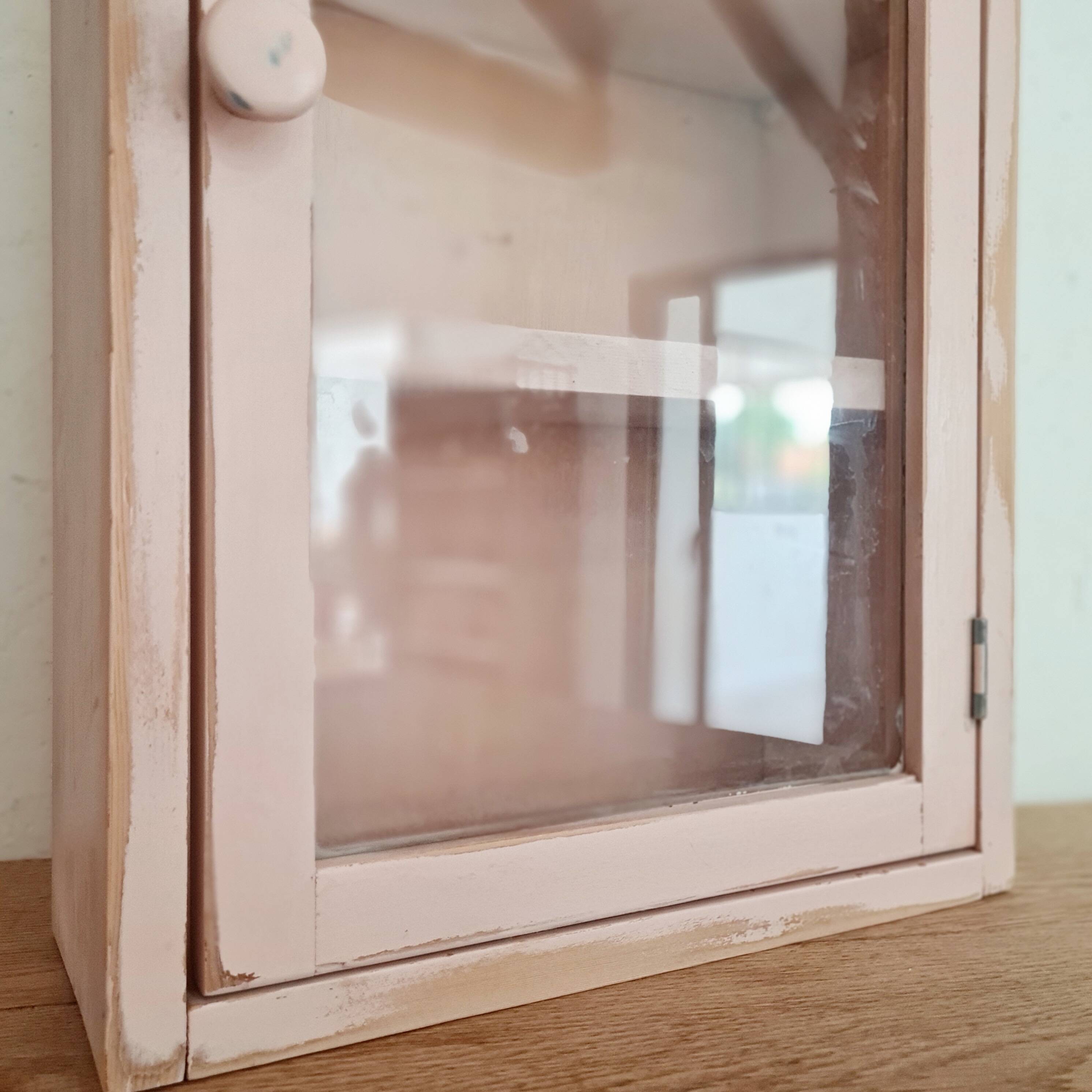 Medicine cabinet in patinated pink wood