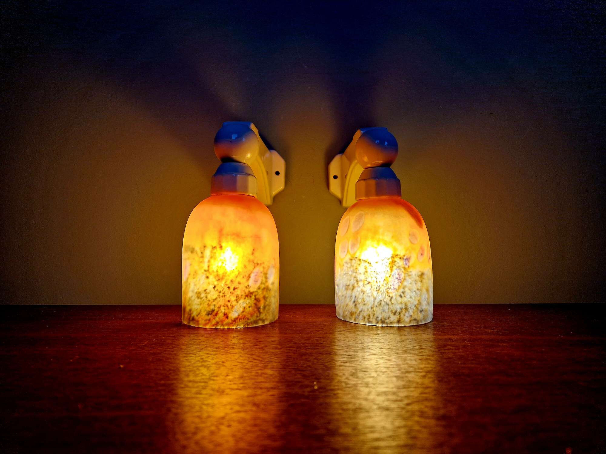 Pair of Art Deco wall sconces in multicoloured porcelain and frosted glass.