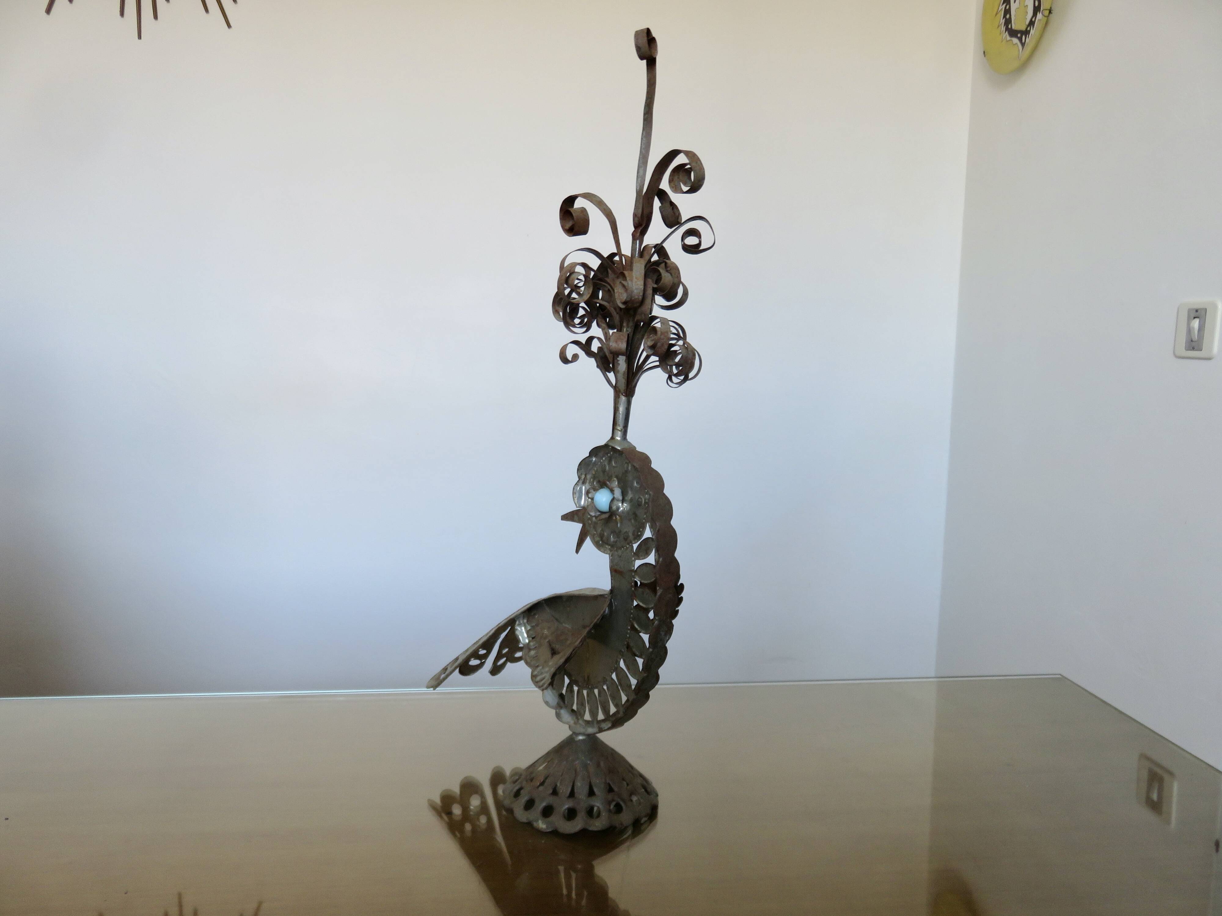 metal sculpture in sheet metal representing a peacock, work from the 1960s