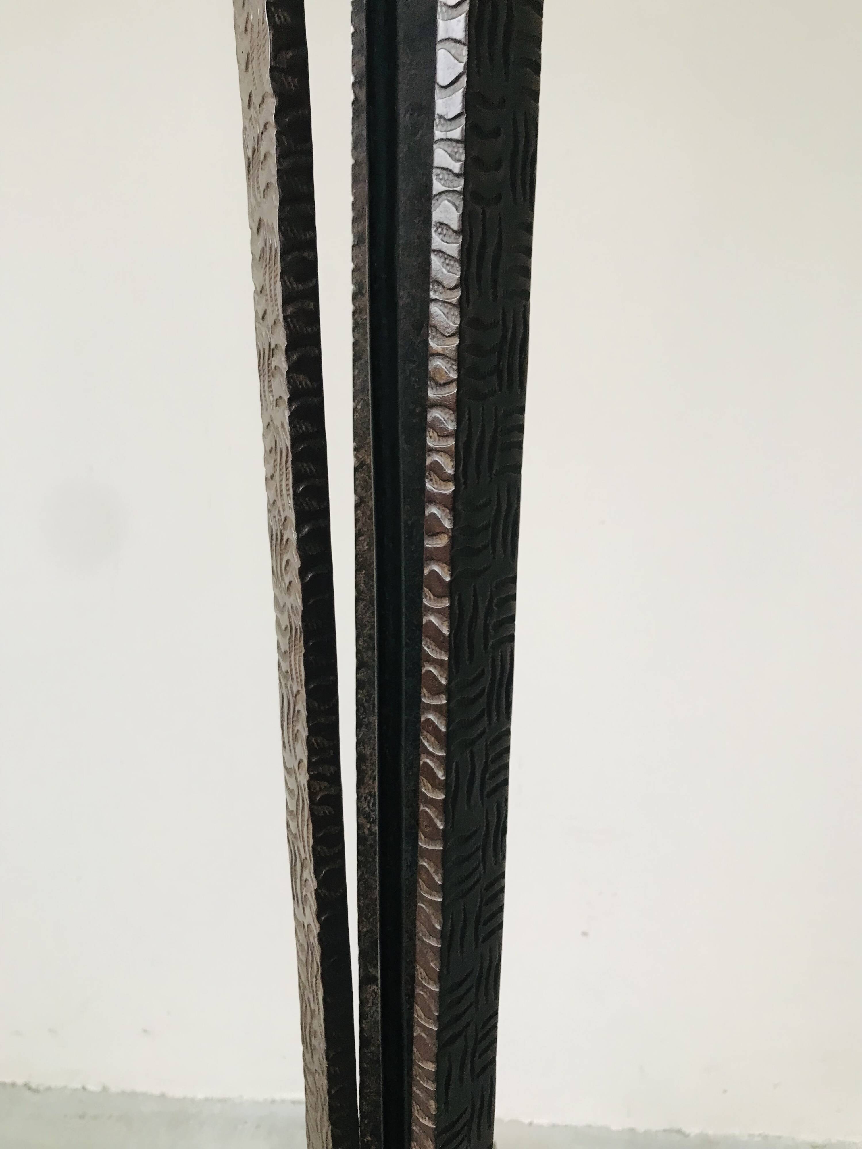 Art deco wrought iron floor lamp decorated with flowers, circa 1930.