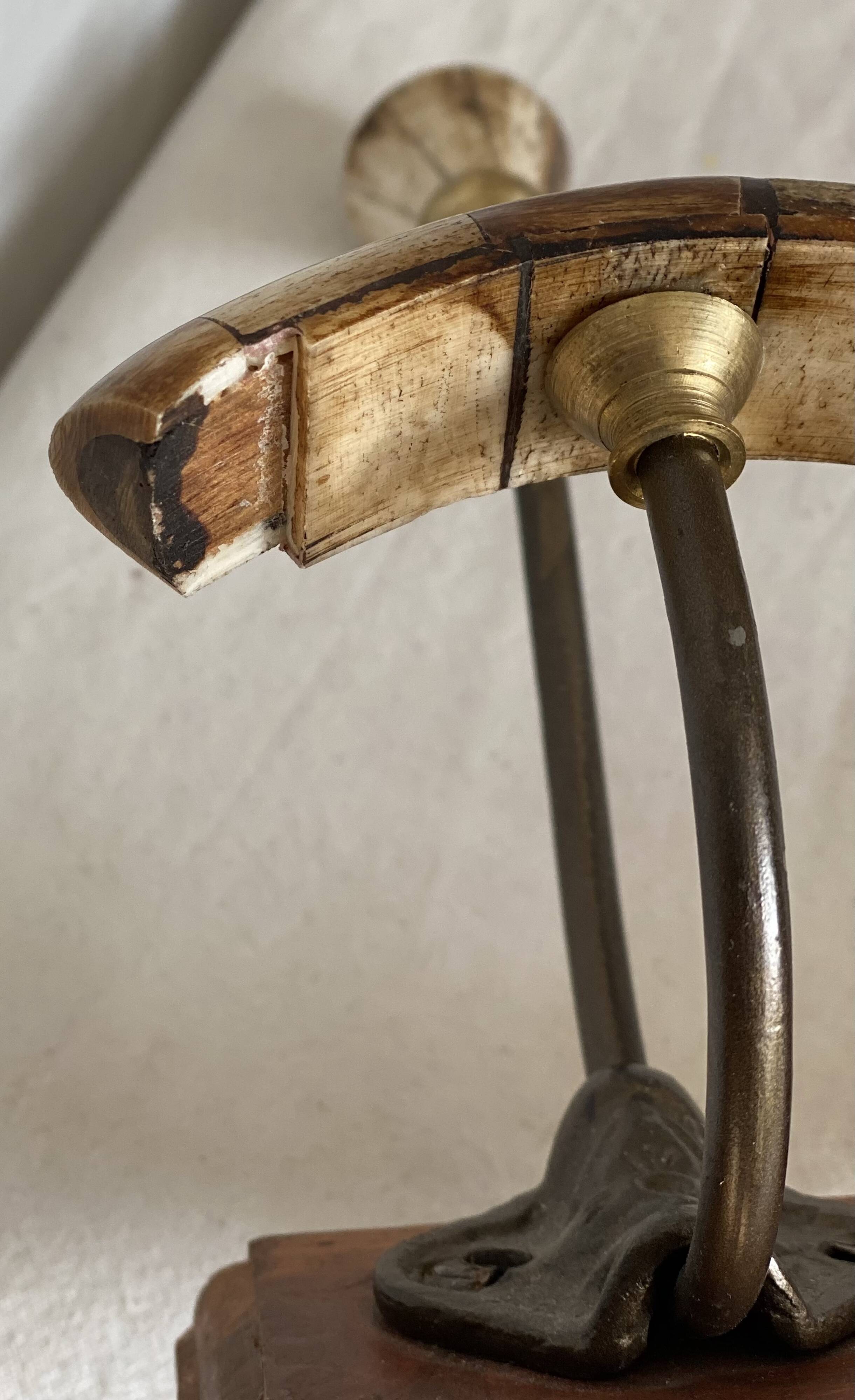 19th-century wall coat rack with 2 metal and horn hooks.