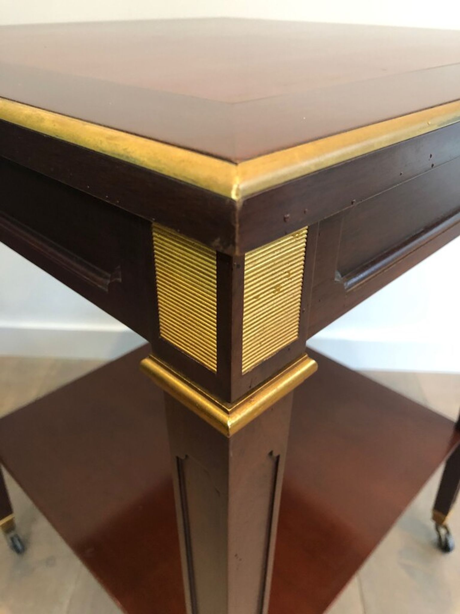 Two-level table in mahogany and brass