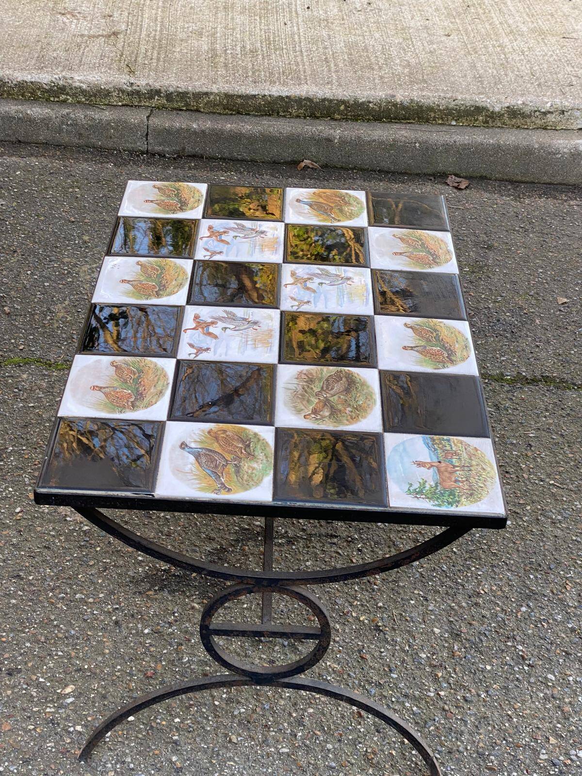 Vintage coffee table with black wrought iron and white tiles.