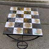 Vintage coffee table with black wrought iron and white tiles.