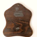 Antique wall mirror in carved wood with a wavy shape and a golden trim.