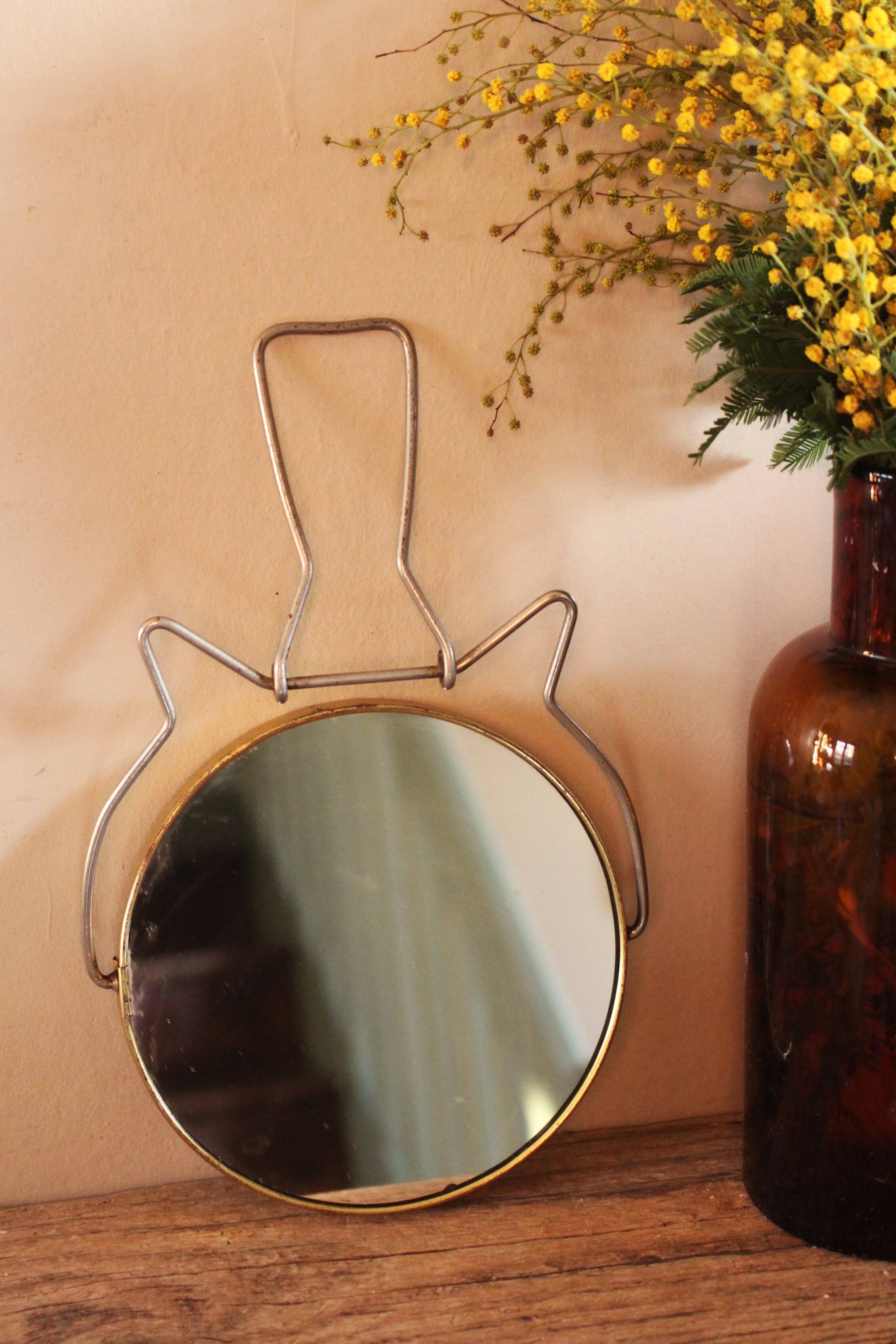 Antique round barber mirror in gilded metal