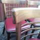 Set of 19 vintage wooden bistro chairs with red faux leather.