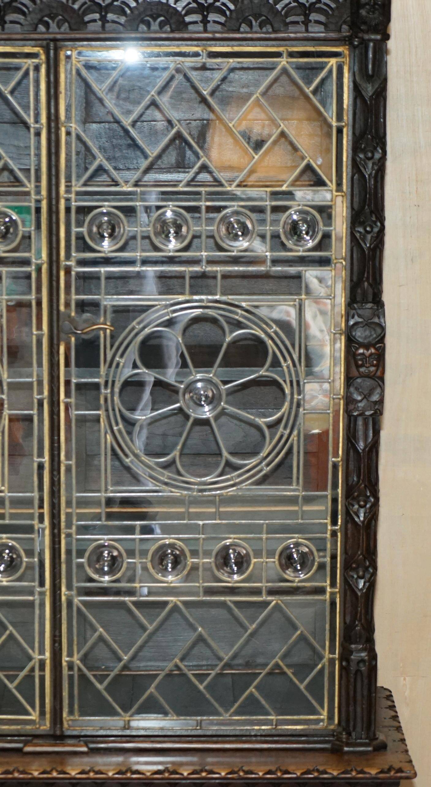 Jacobean hardwood library with carved panels and glass doors.
