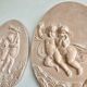 Pair of putti medallions
