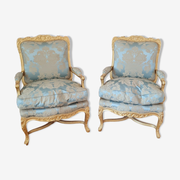 Pair of Louis XV style gilded wooden armchairs