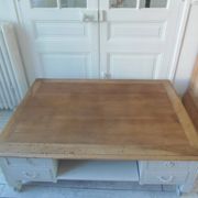 Coffee table on casters, made from an old desk, pearl gray base and belt.