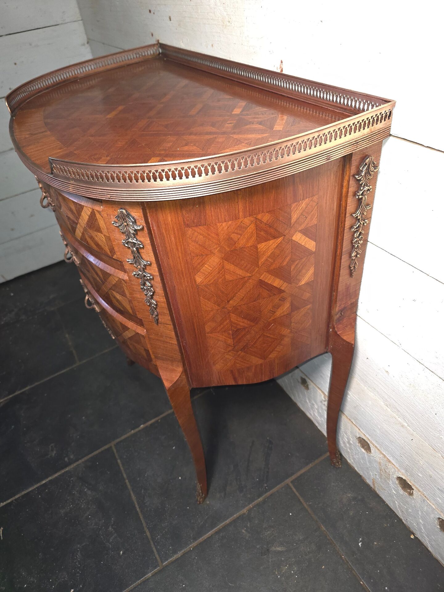 Small curved chest of drawers in Louis XV style with marquetry.