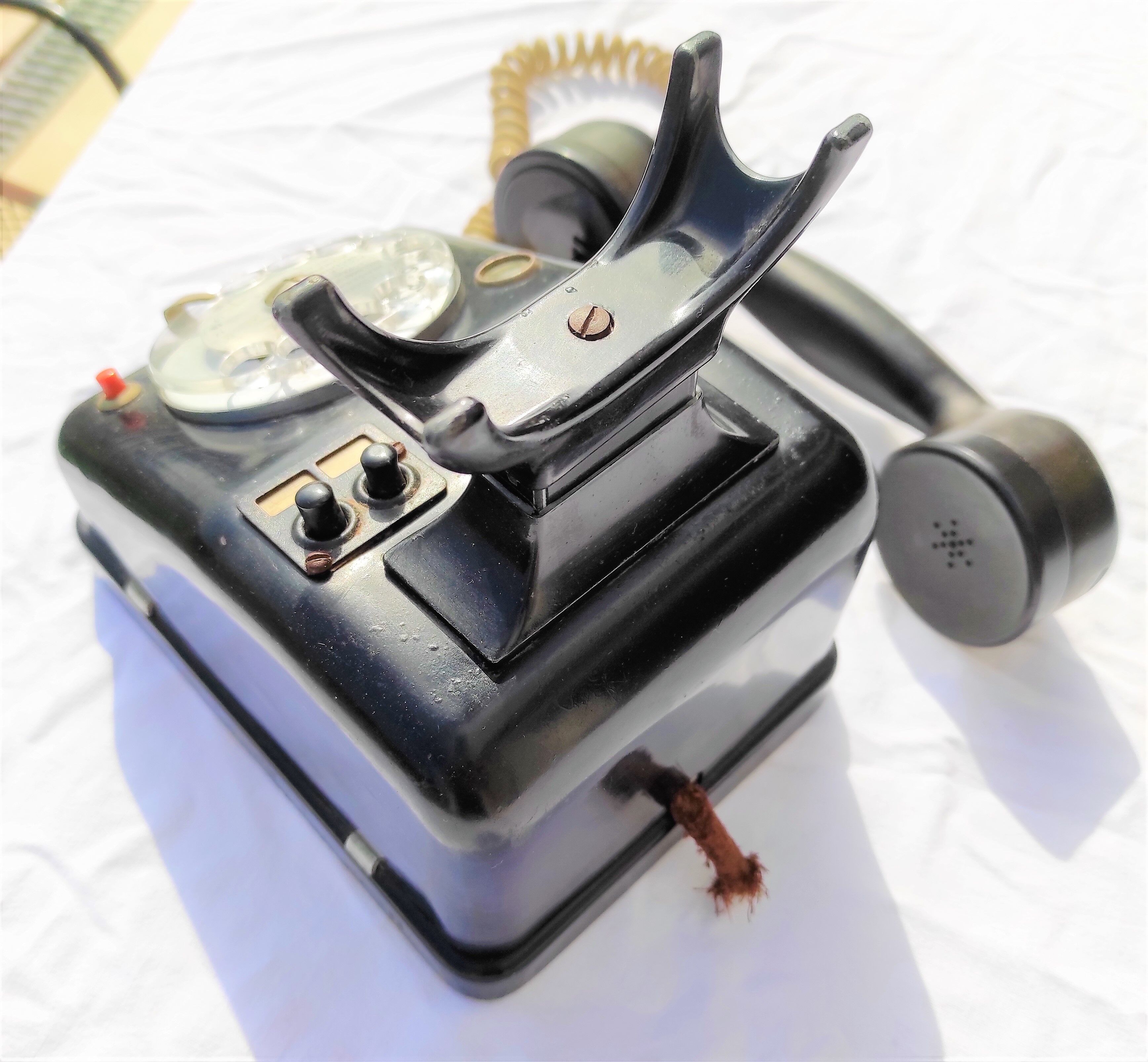 Telephone in black bakelite dial with call system