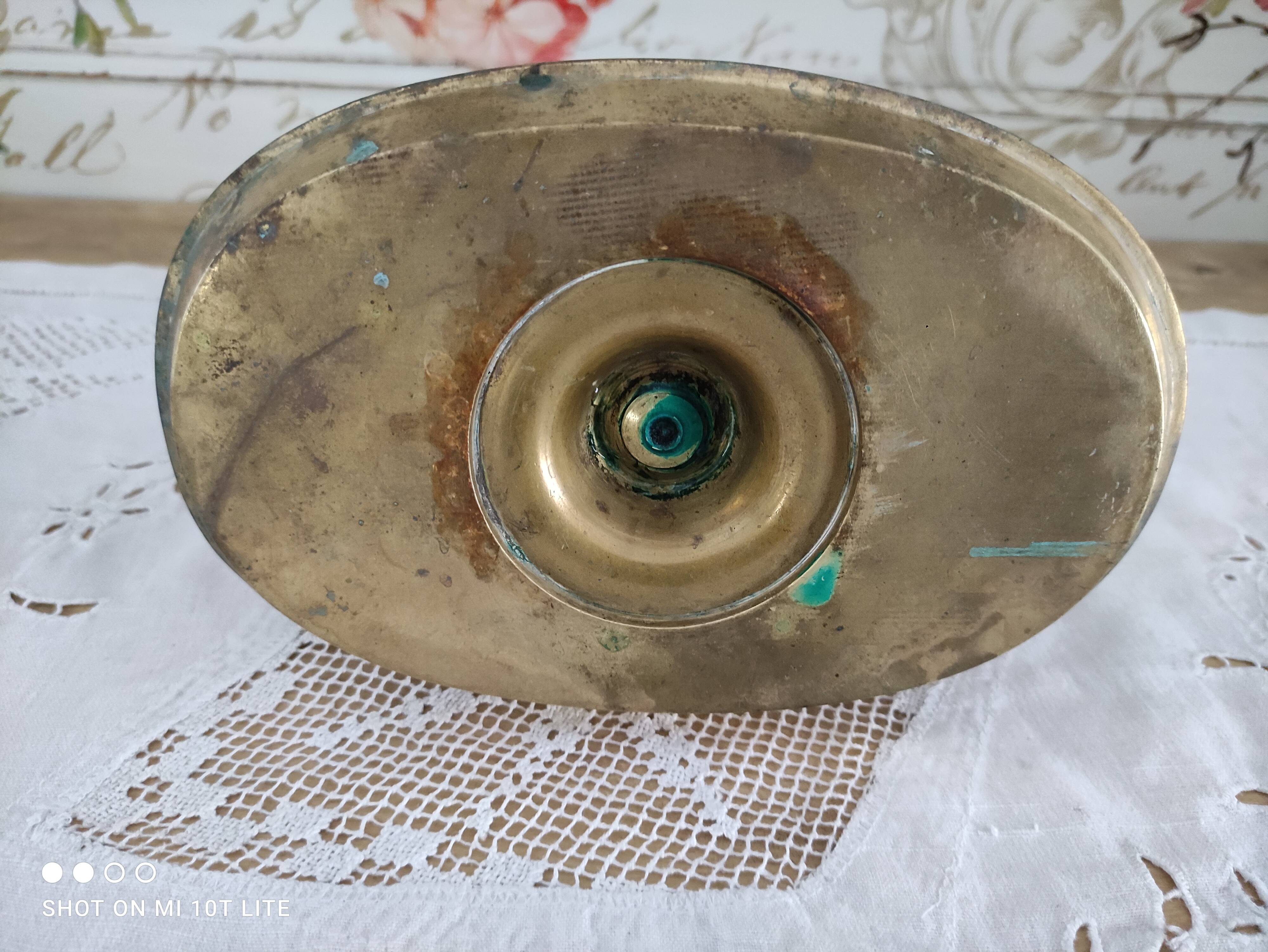 Brass pusher candle holder on oval frame