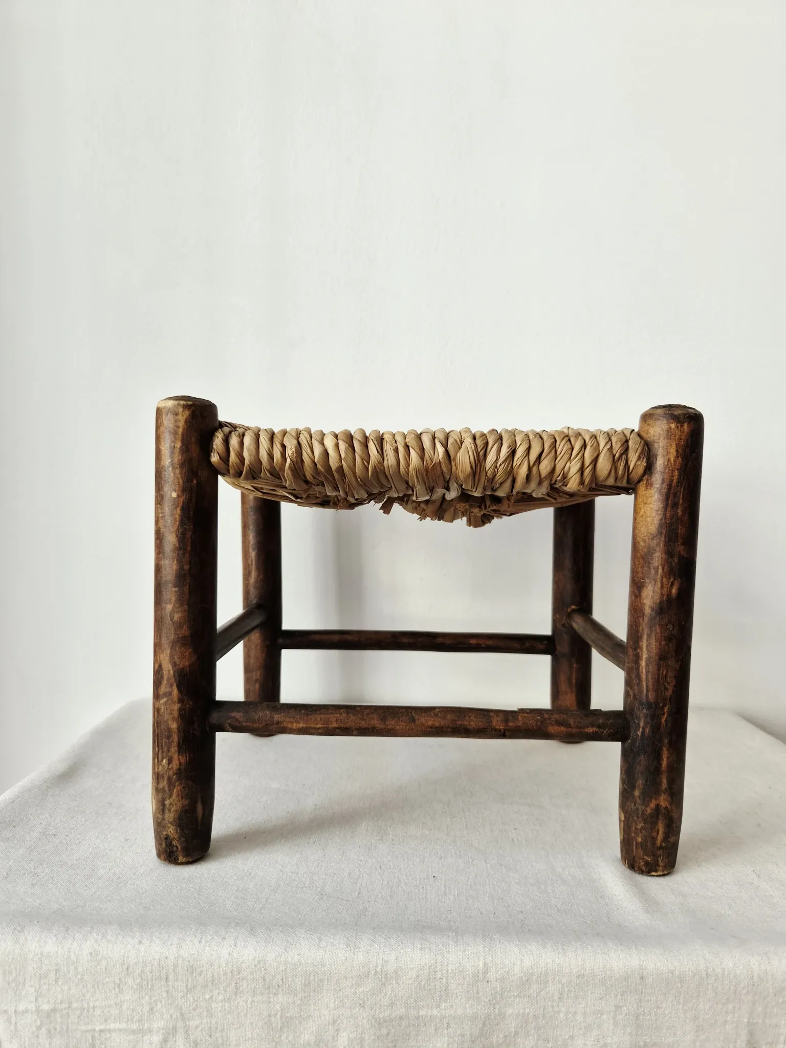 Small rustic vintage wooden and straw stool -