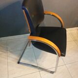Chairs in leather, walnut and chrome