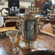 Silver-plated champagne bucket with ring handles.