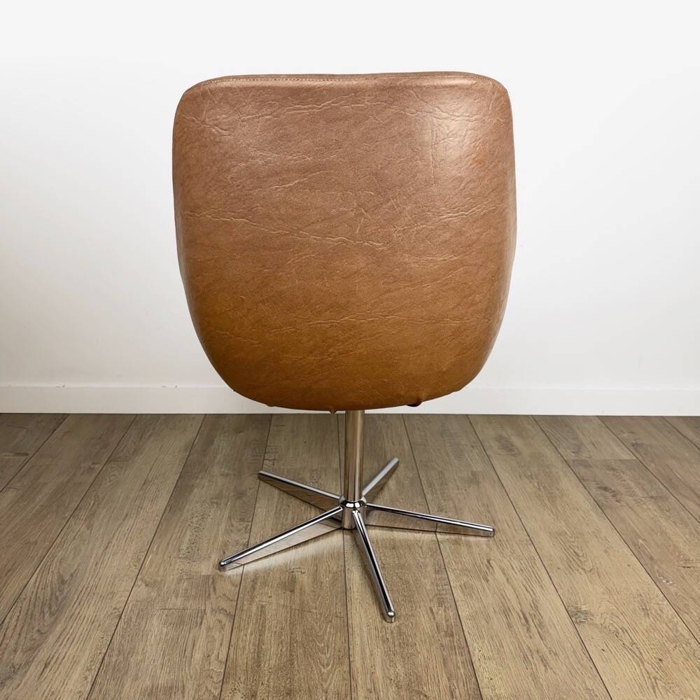 1970s swivel chair with faux leather shell and chrome.