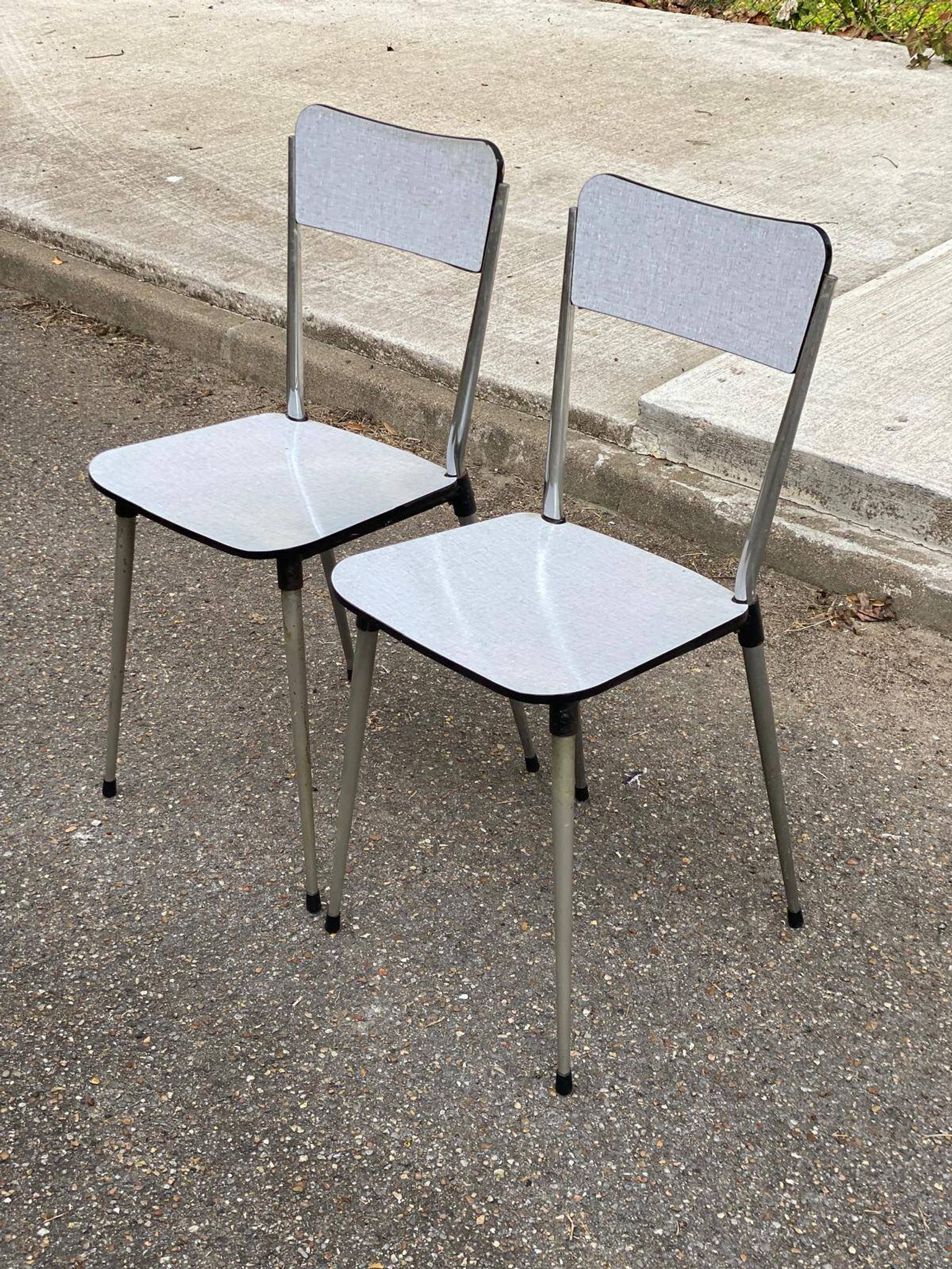 2 beige Formica and steel chairs from the 1980s.