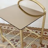 Pair of bedside tables with gold metal and mirrored glass top.