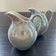 Pair of iridescent blue pitchers