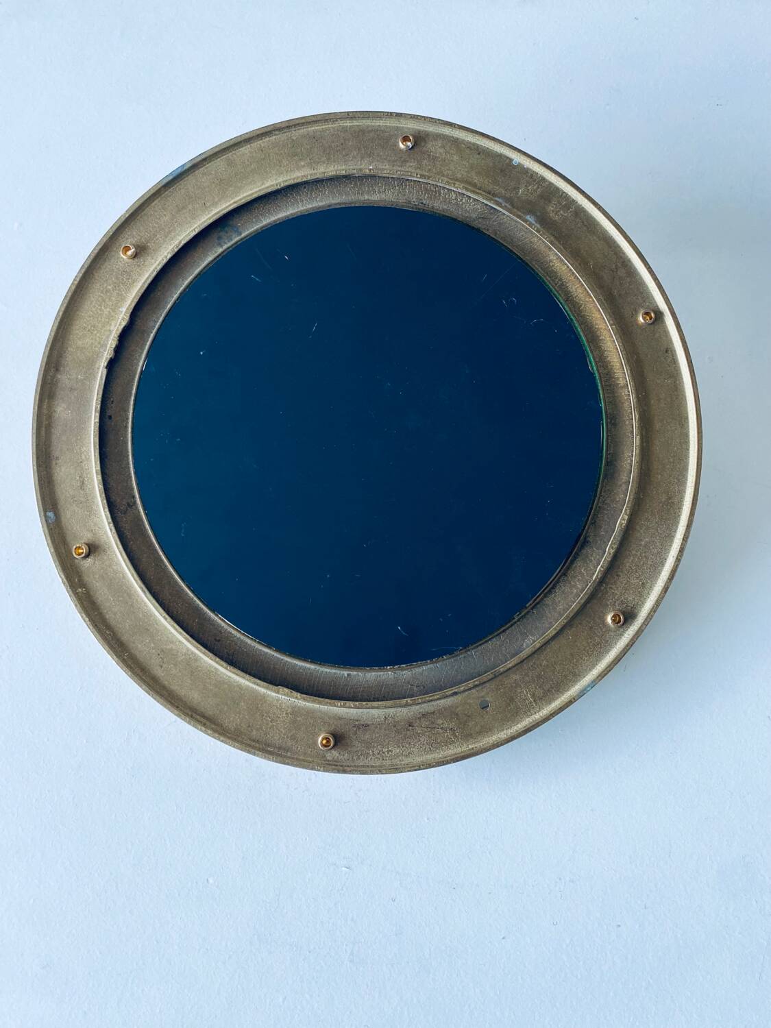 Porthole mirror in gilded brass