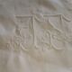 Antique embroidered linen sheet with a monogram.