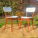vintage wooden chairs with white faux leather