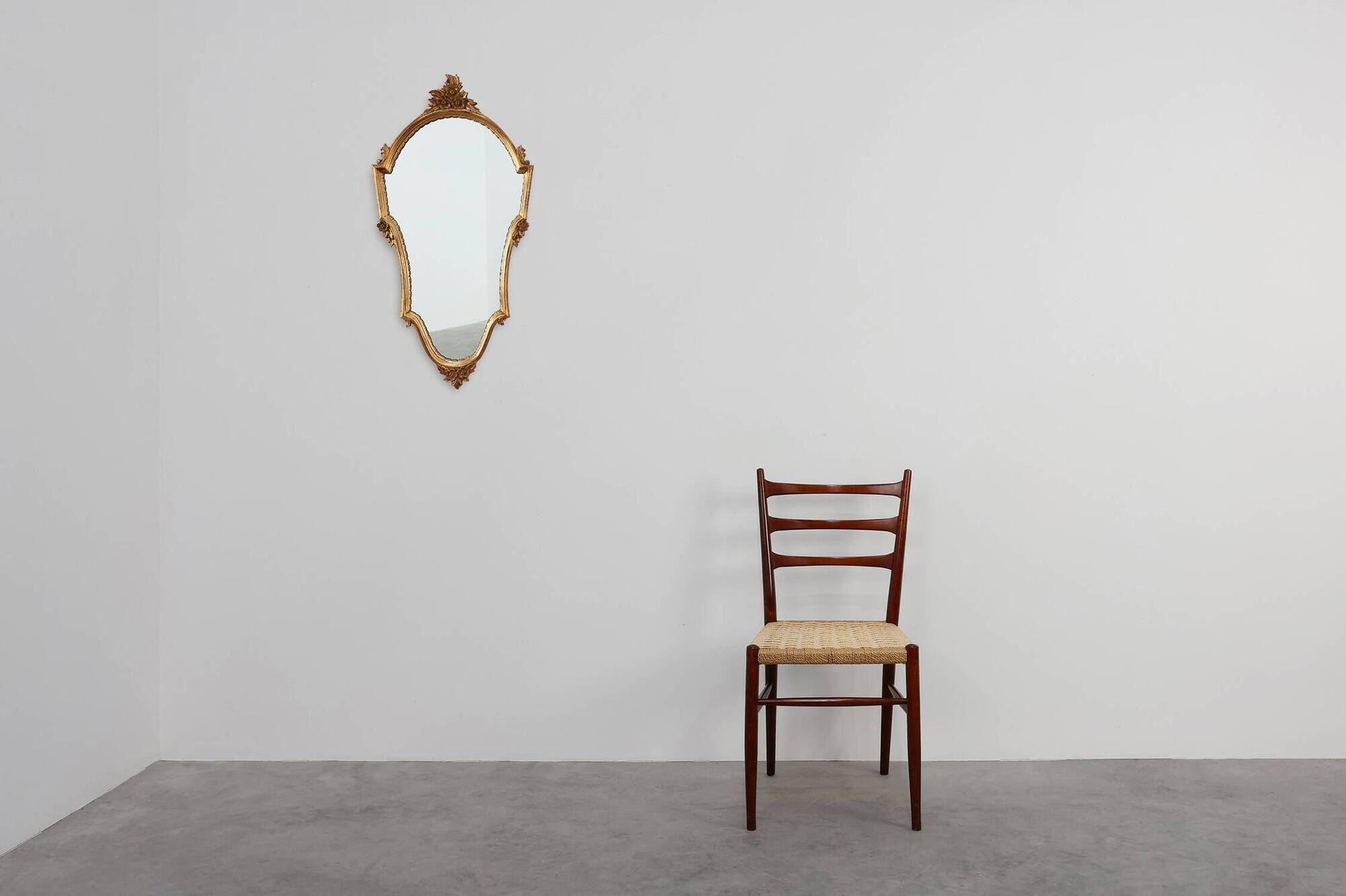 20th Century Louis XVI style giltwood mirror with ornate crest, France
