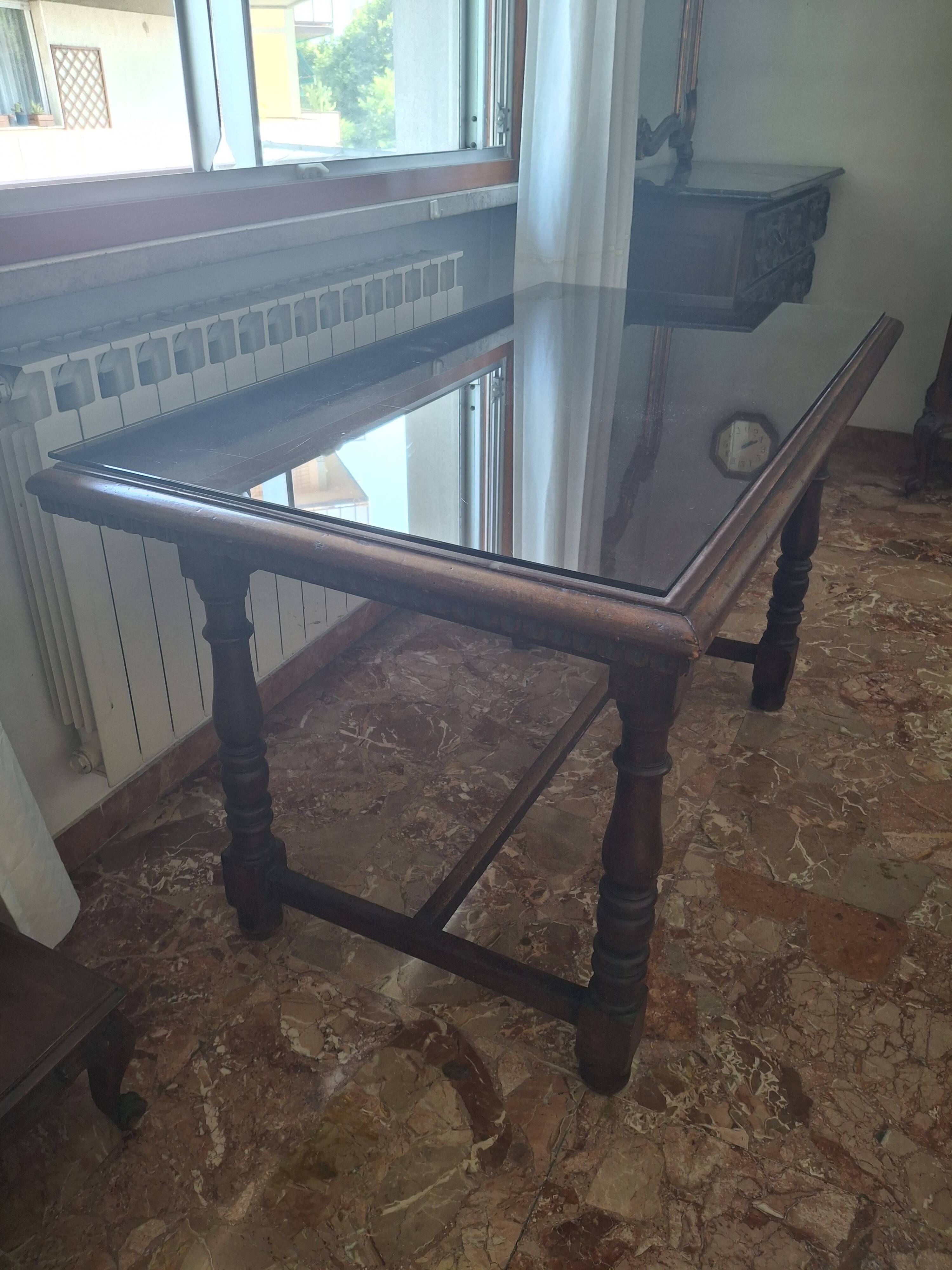1960s Italian wooden table with a glass top.